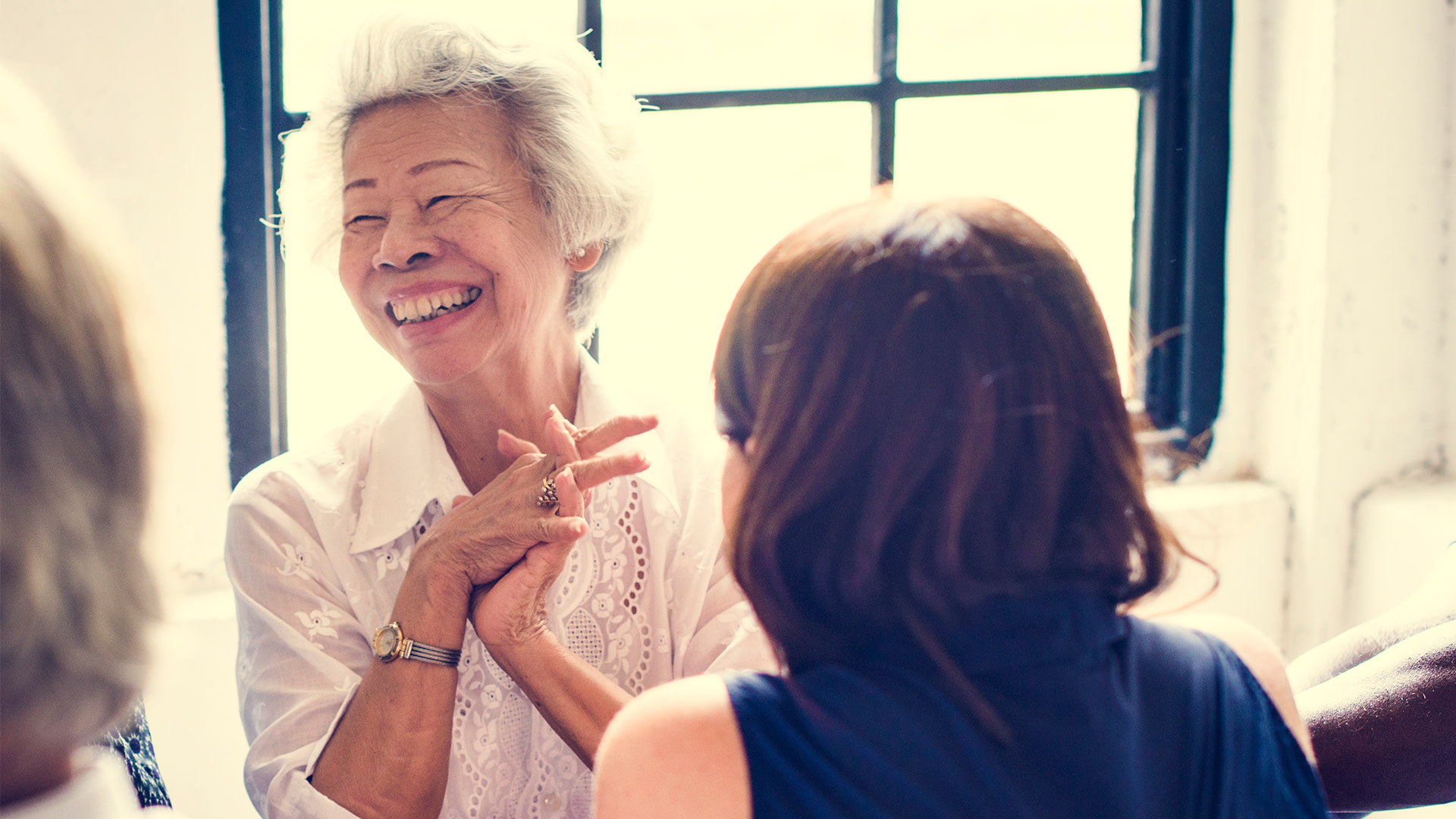 Woman laughing at a meeting.