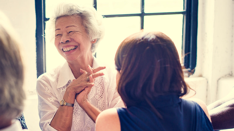 Woman laughing at a meeting.