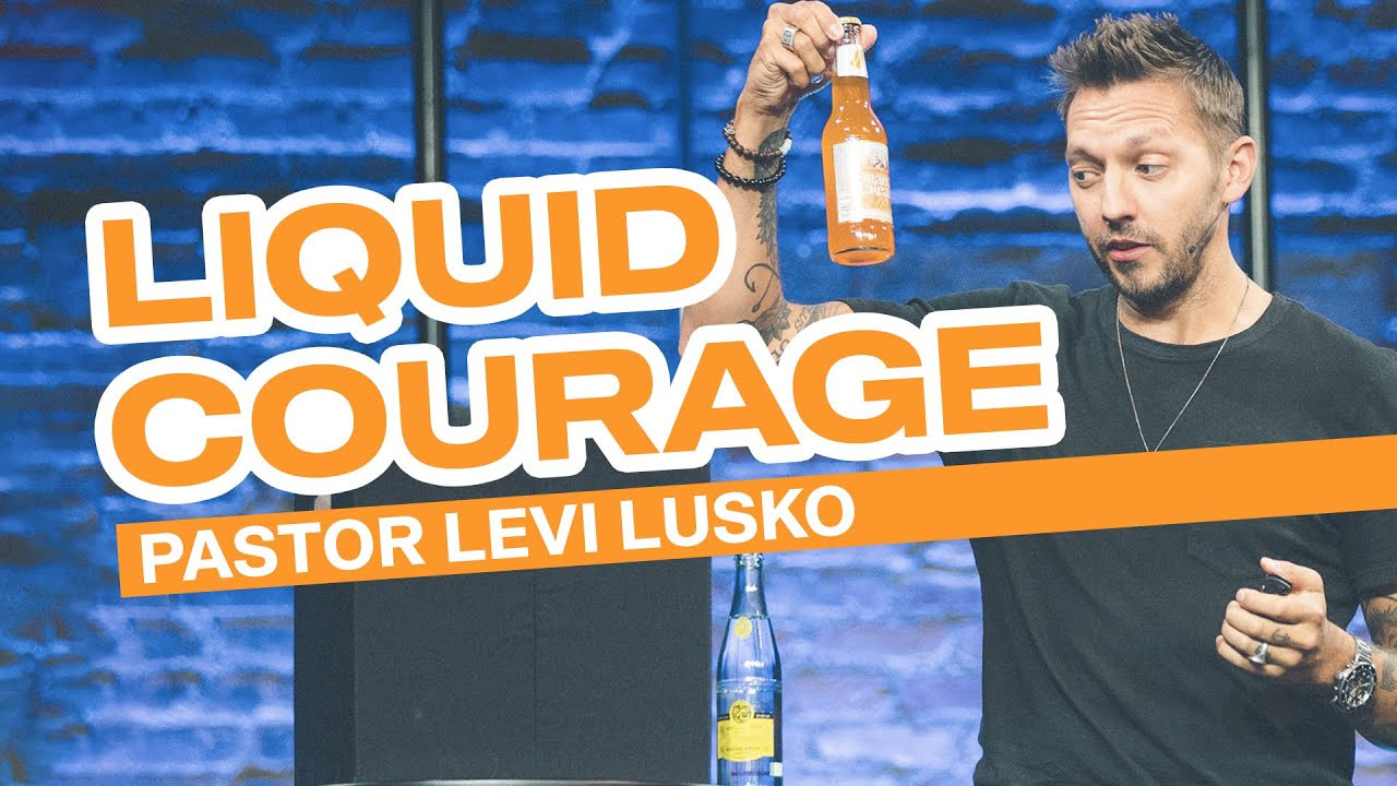 Levi Lusko holding up a bottle of orange soda