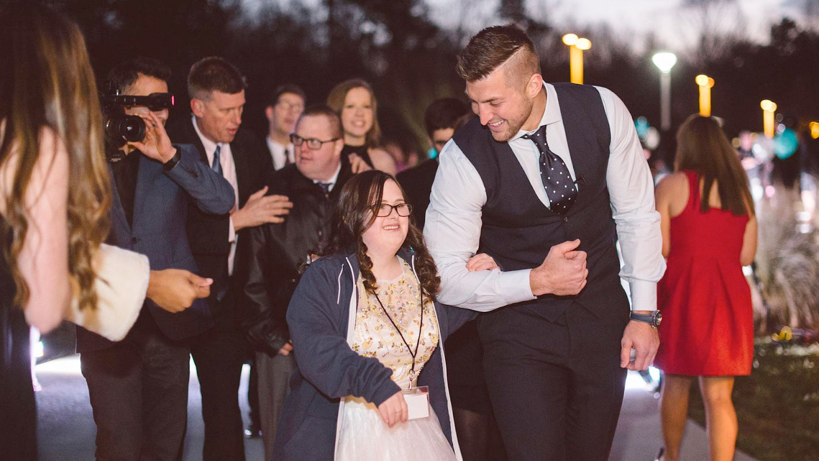 Tim Tebow dressed up and escorting a young lady to prom