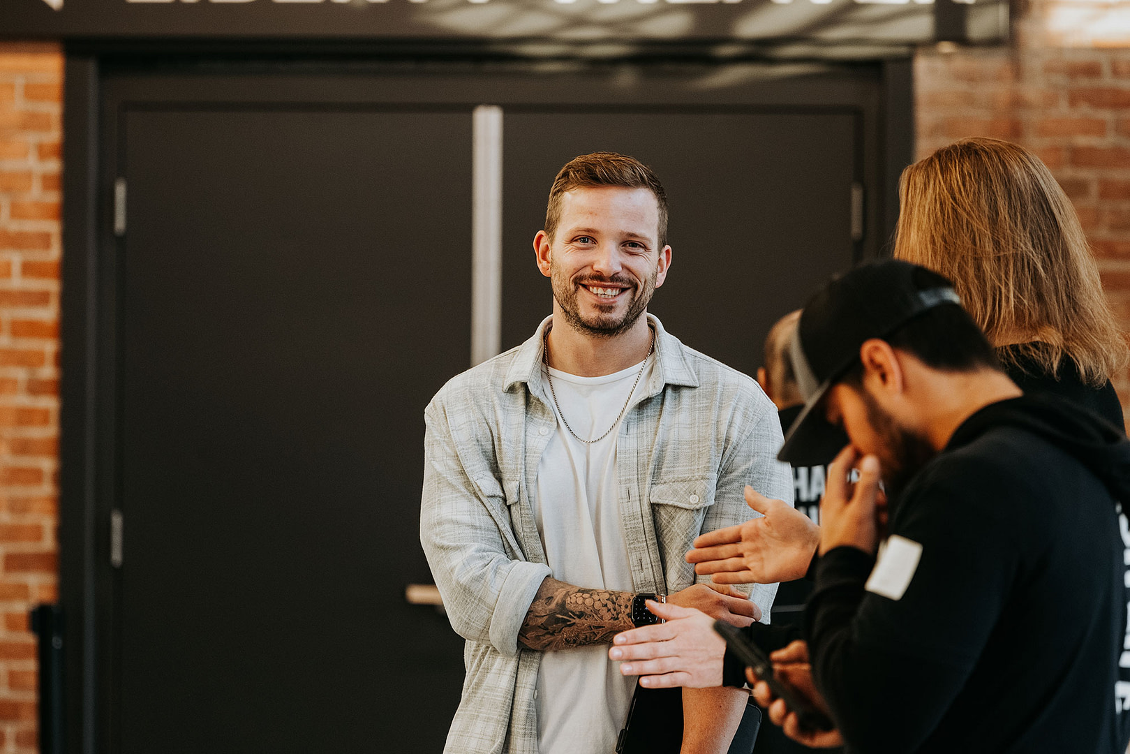 A man takes a break from attending church with friends to smile for the camera