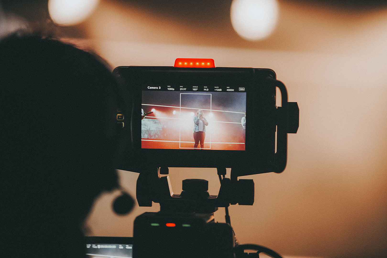 View of the back of a camera filming an event