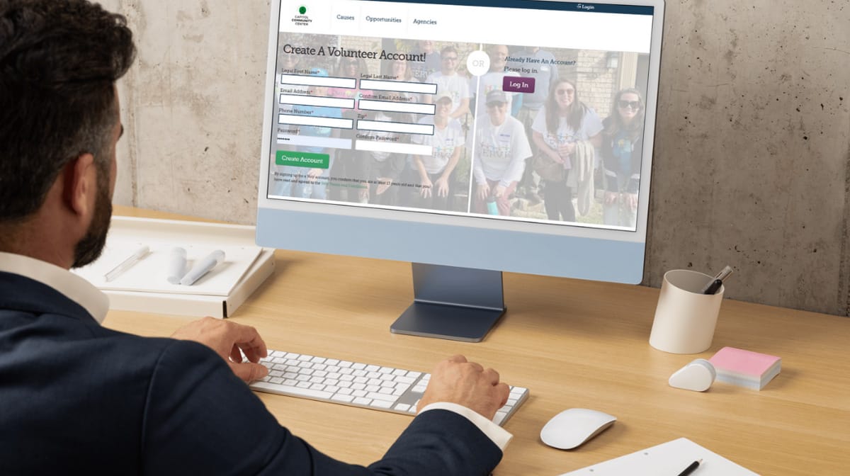 Man creates volunteer account on computer screen