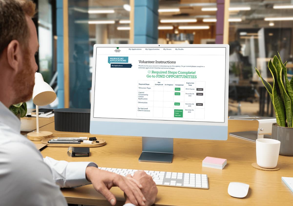 Man reviewing volunteer instructions on computer screen.