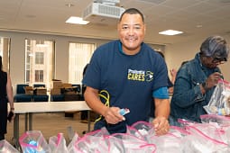 Volunteers assembling care packages in an office.
