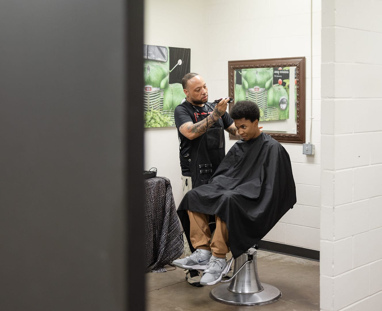 Barber giving a haircut in salon.