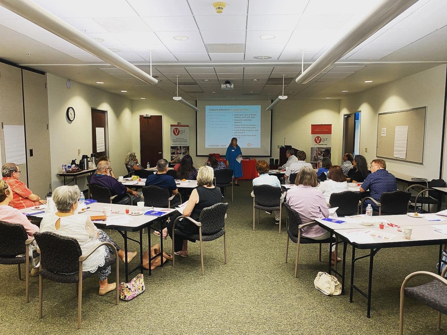 People attending a presentation in a conference room.