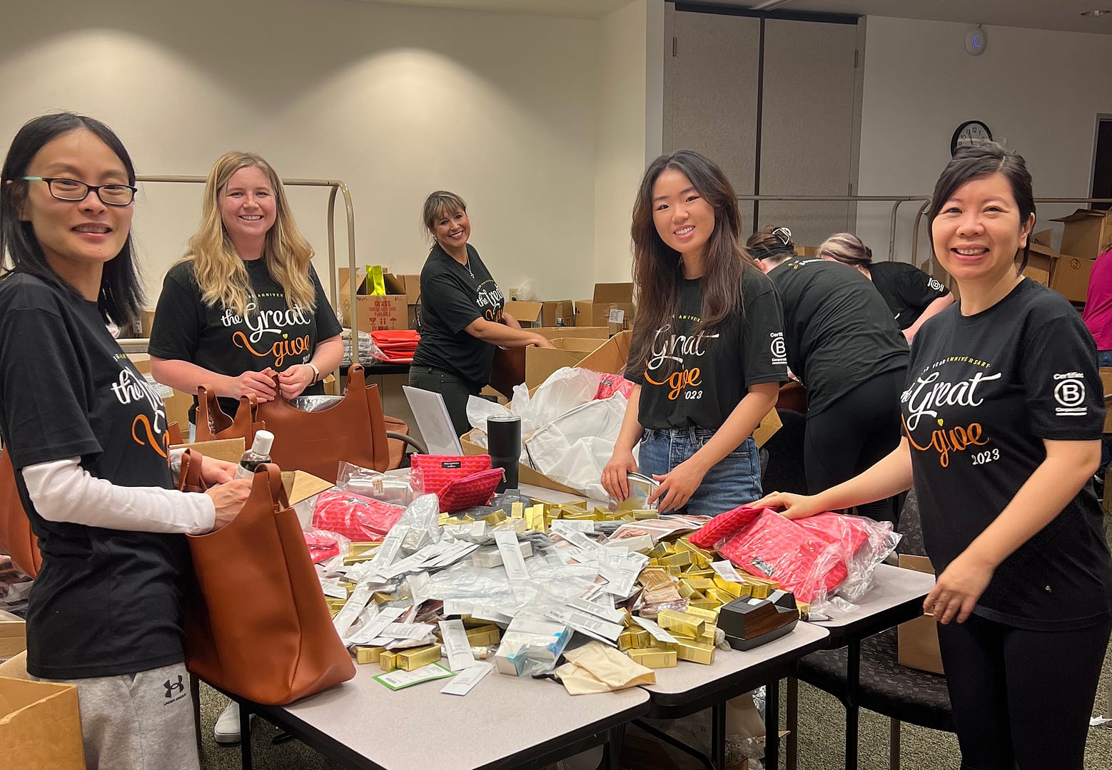 Volunteers packing items for charity donation event.