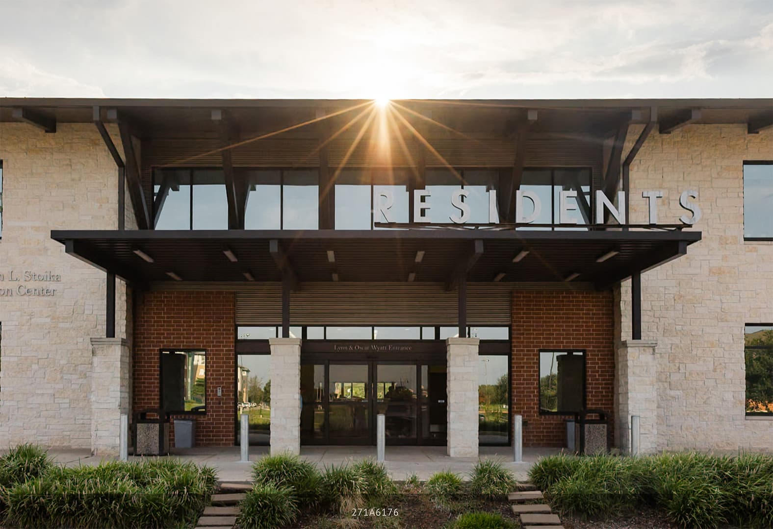Building entrance with RESIDENTS sign and sunburst.