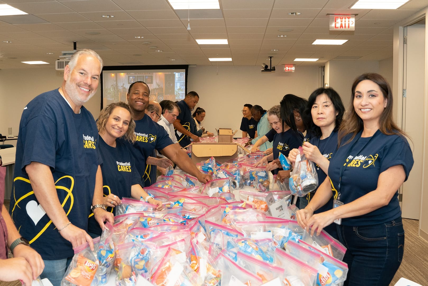 Volunteers packing bags for charity event.