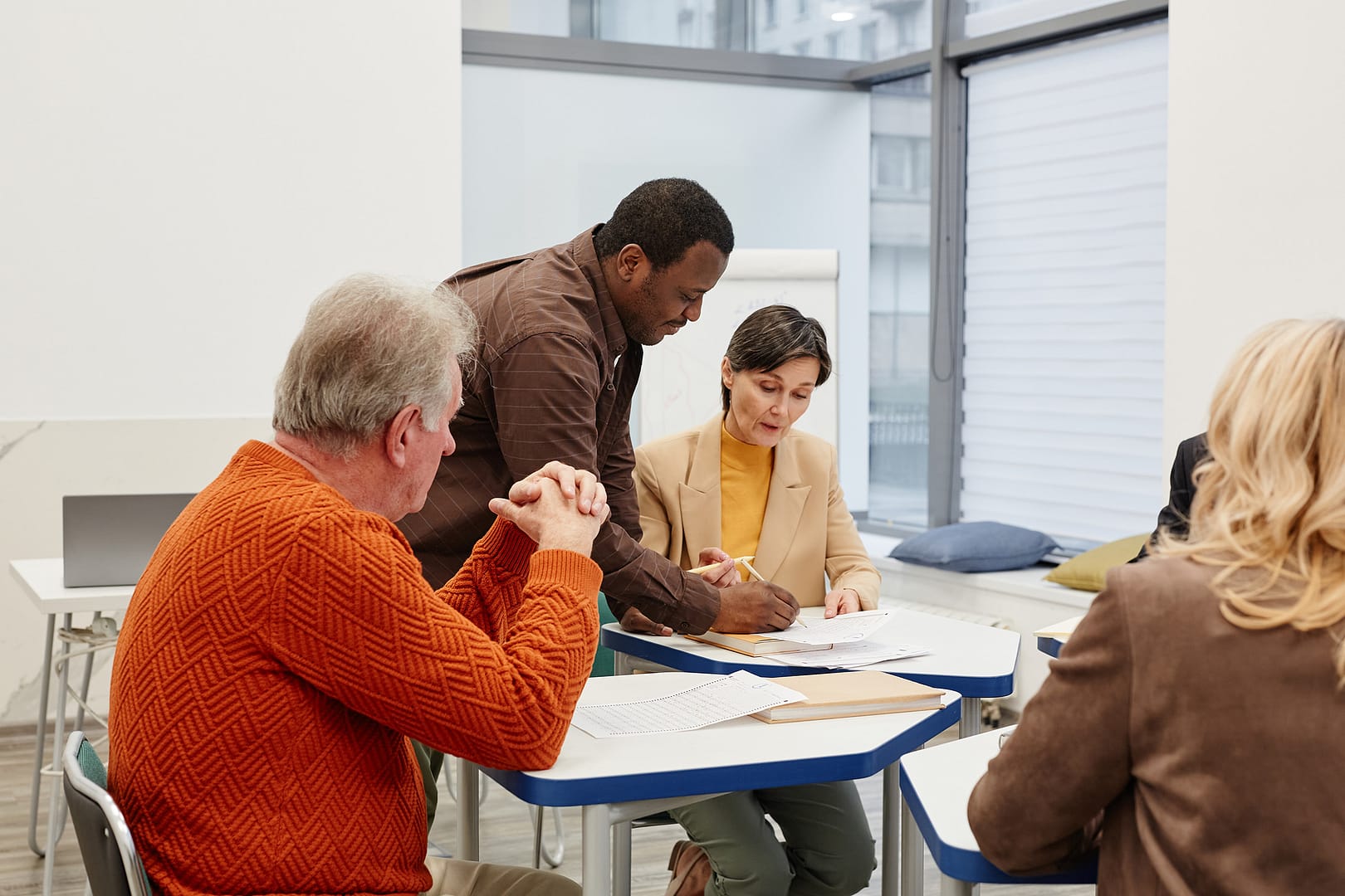 Group collaborating in business meeting room.