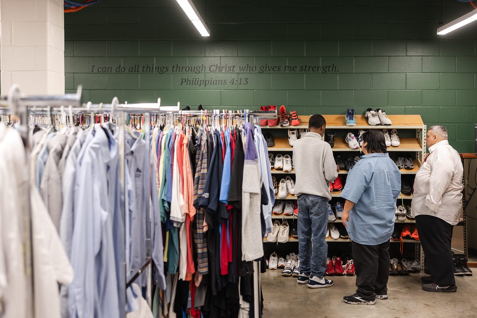 People browsing clothes and shoes in a store.