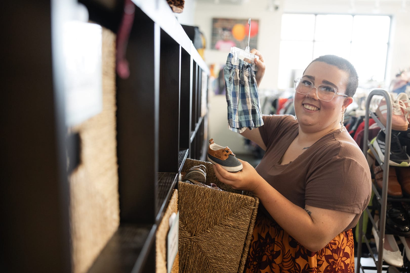 Person shopping for children's clothes and shoes.