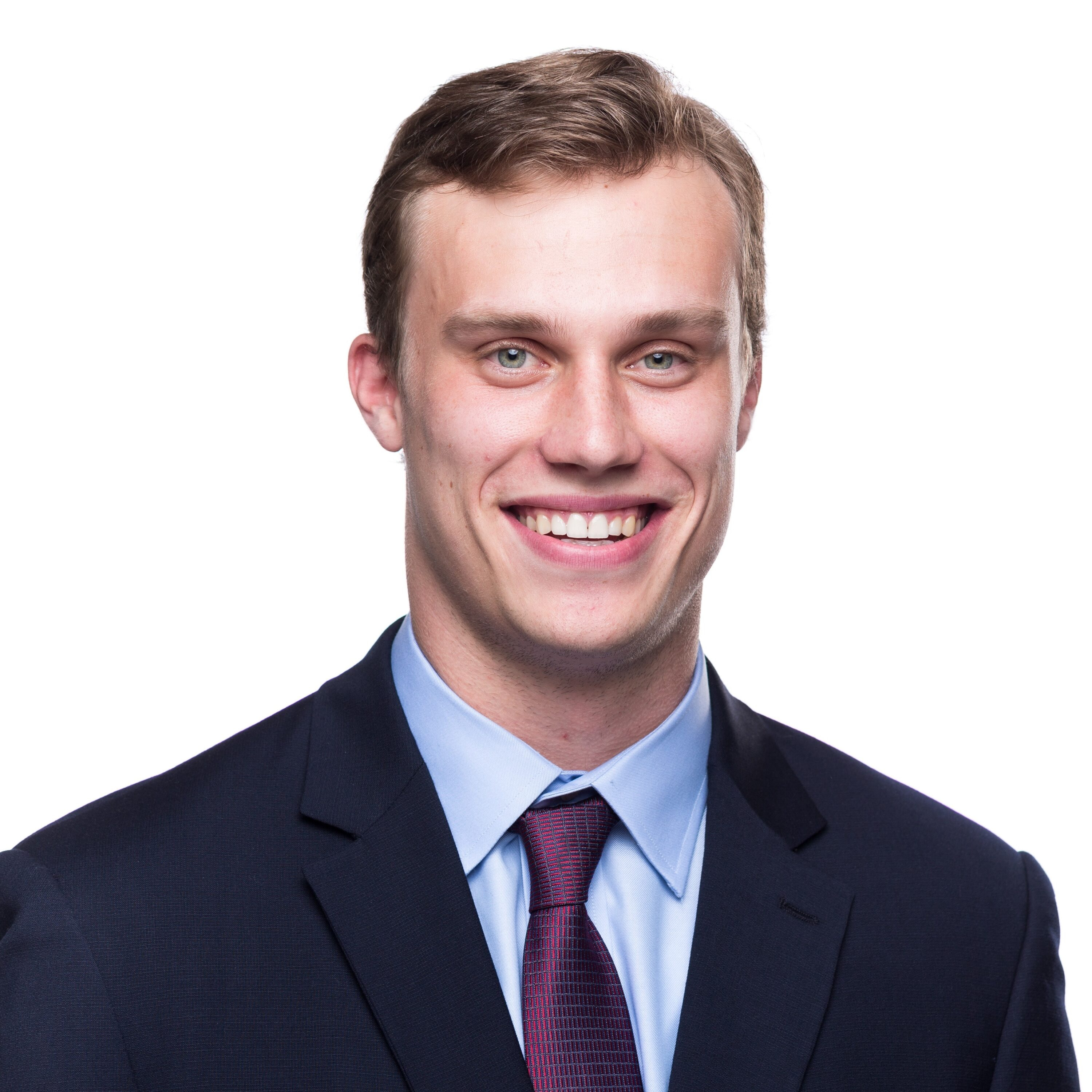 Smiling man in formal suit and tie.
