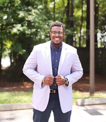 Smiling man in a suit outdoors