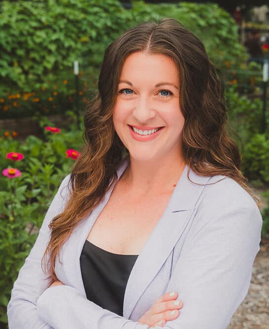 Woman smiling in a flower garden.