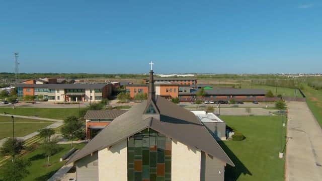 Aerial view of a church and surrounding buildings.