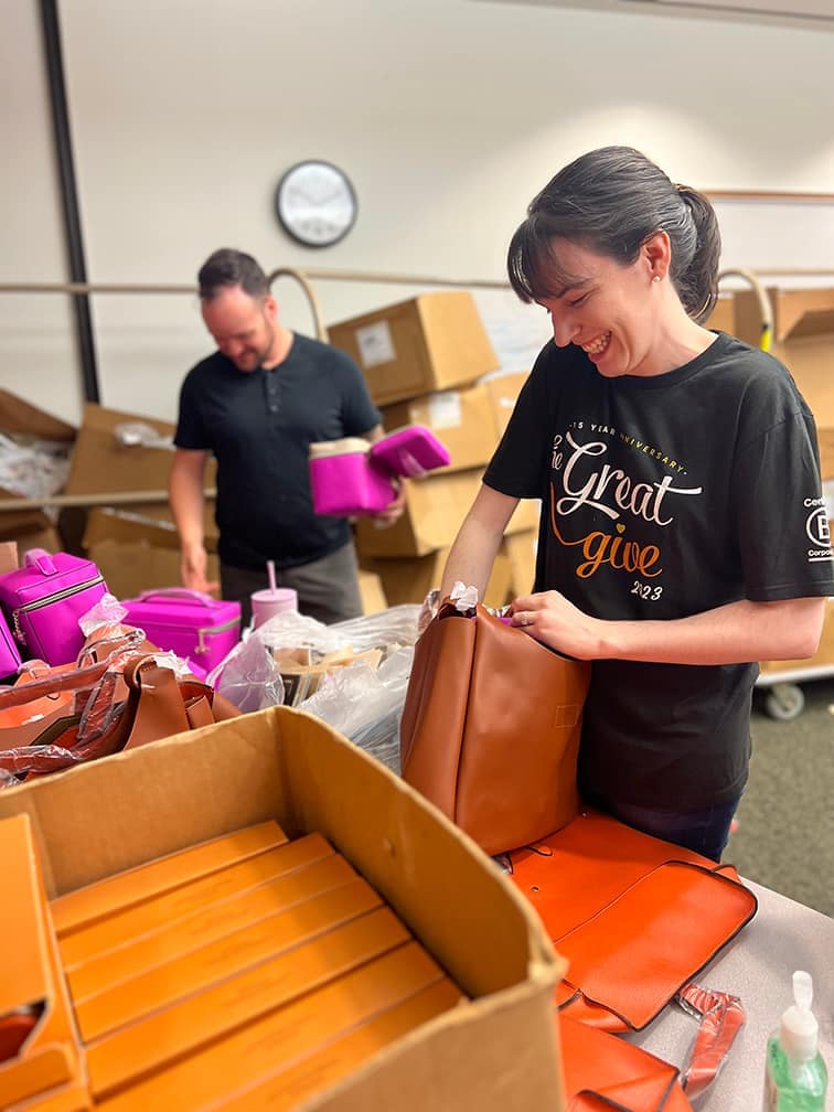 Volunteers packing bags at charity event.