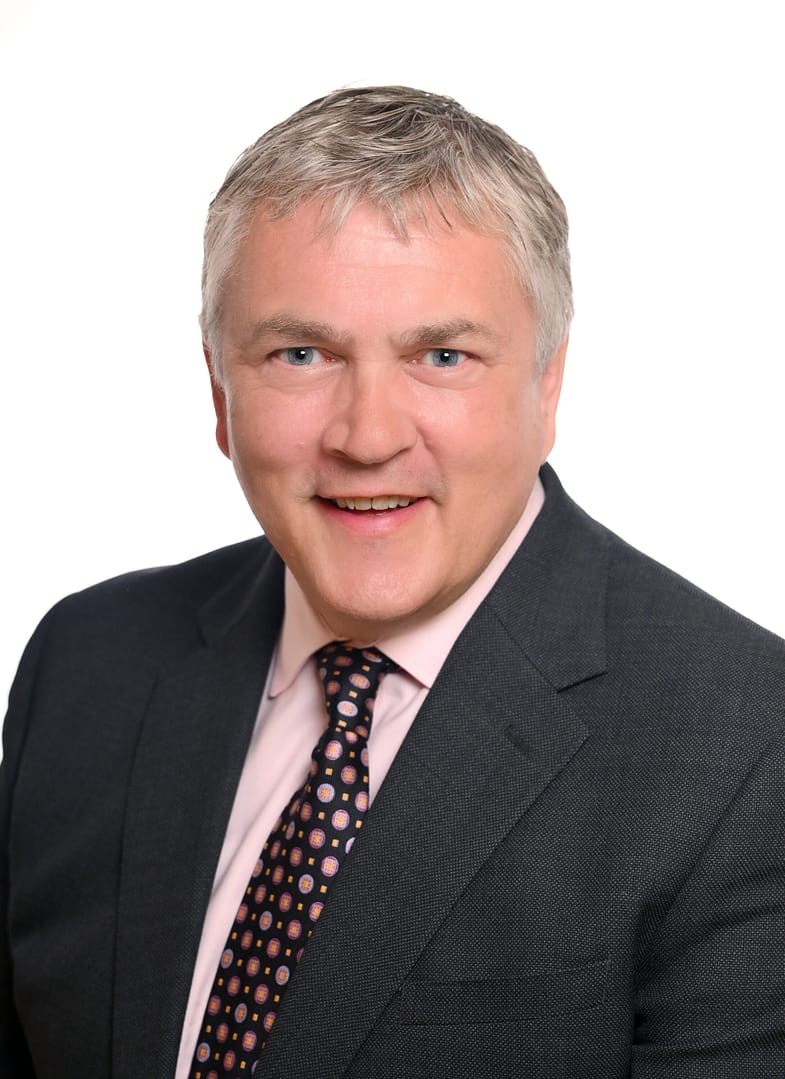 Smiling person in formal attire portrait.