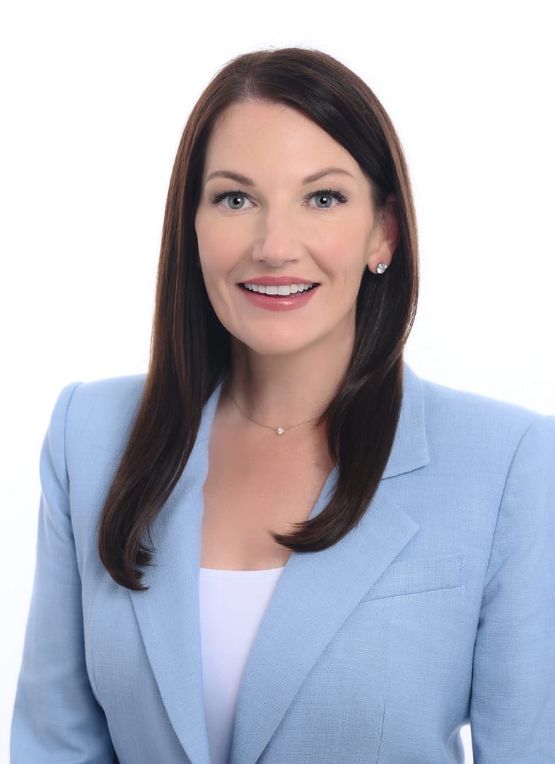 Smiling woman in blue blazer portrait.