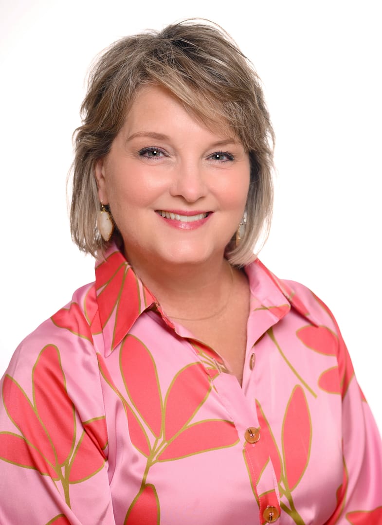 Smiling woman in pink floral blouse