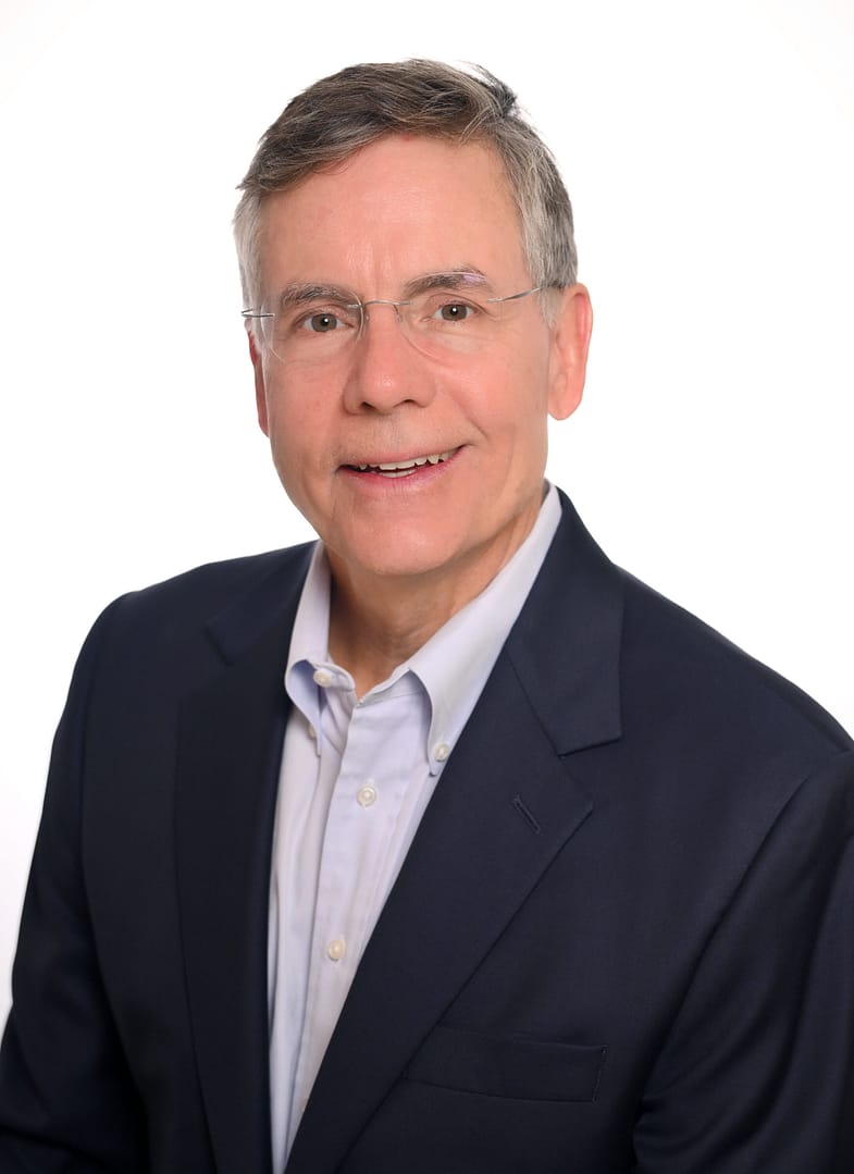 Smiling man in business suit against white background.