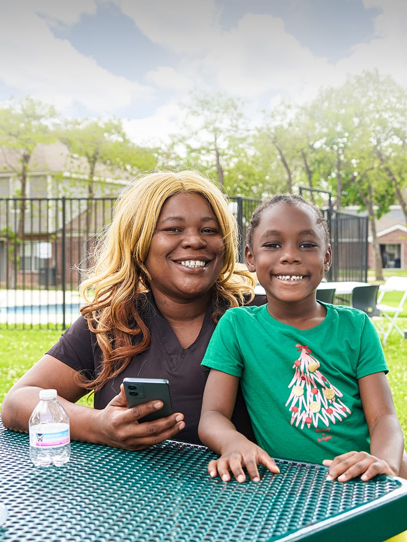 mom and daughter smiling