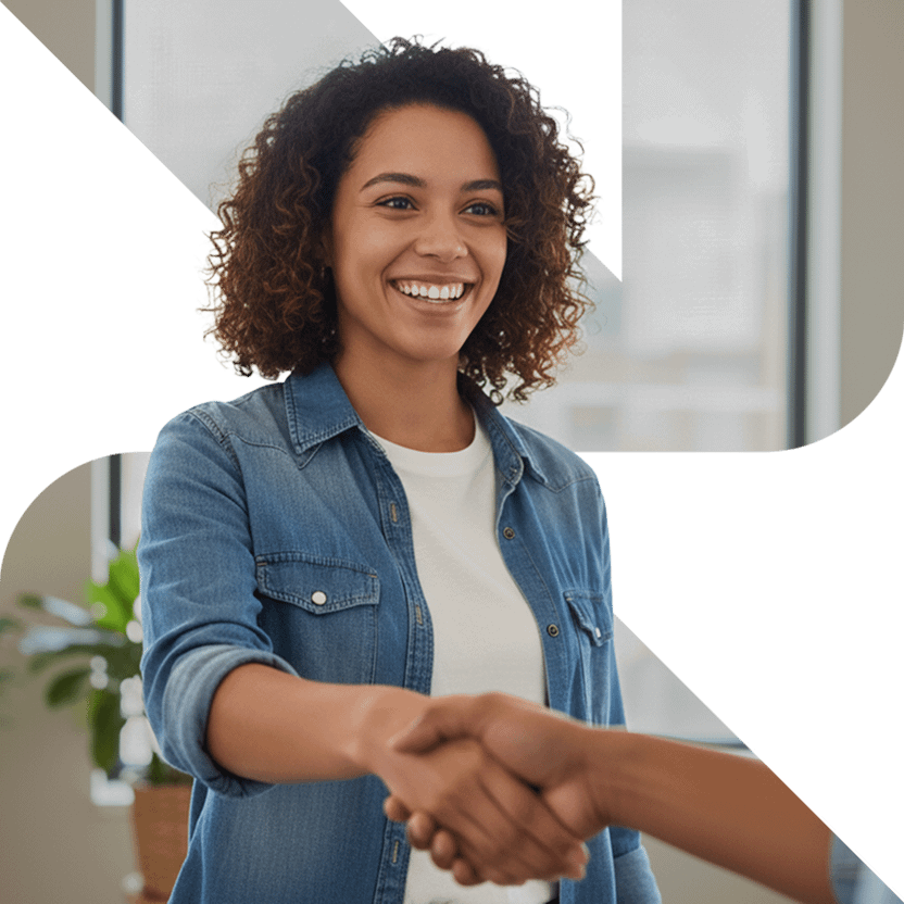 Smiling woman shaking hands at meeting.