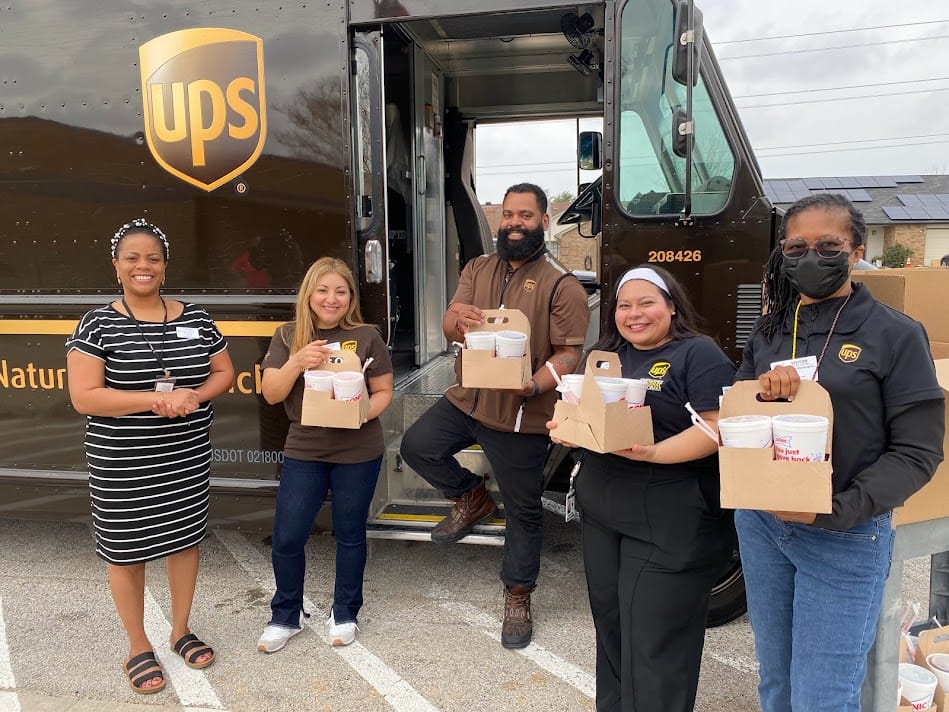 UPS employees distributing packages from truck